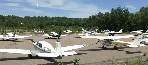 Image of the planes parked at the Killarney airport on a sunny summer day.